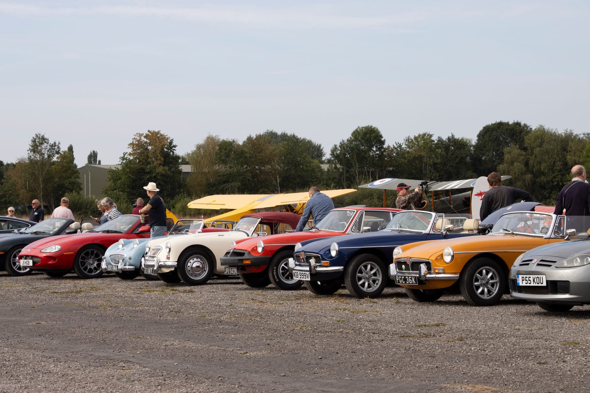 Aerial view of Wings & Wheels showing classic aircraft lined up with vintage cars and crowds